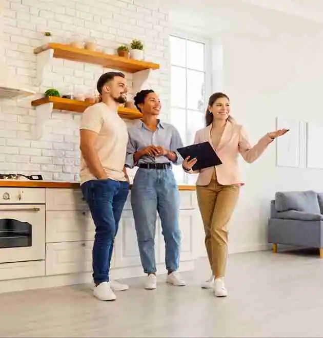 A property manager shows prospective tenants through a newly completed co-living conversion property